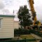 Picture of a caravan being lifted by a crane at Orchard Holiday Park, Wells-next-the-sea, Norfolk