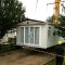Picture of a caravan being lifted by a crane at Orchard Holiday Park, Wells-next-the-sea, Norfolk